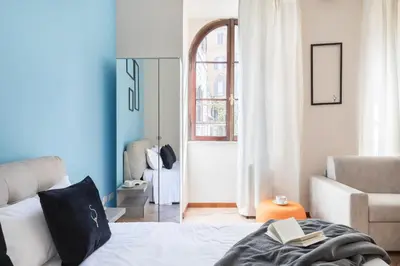 a bedroom with a bed with a book on it at A World Aparts - 40 Sforza in Rome