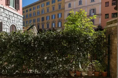 a group of trees in front of a building at A World Aparts - 40 Sforza in Rome