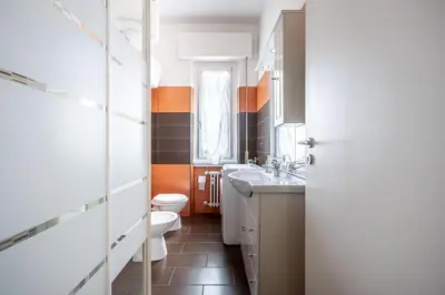 a bathroom with a toilet and a sink at Caracciolo Apartment - Metro San Giovanni in Rome