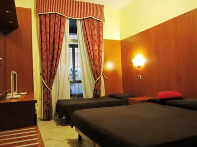 a hotel room with two beds and a window at B&B Rome Terminal House in Rome