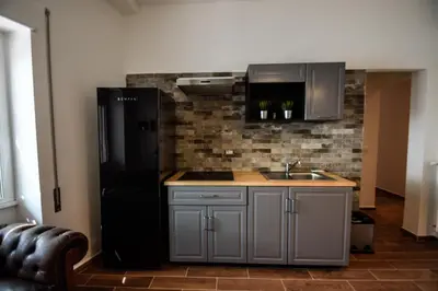 a kitchen with a black refrigerator and a sink at Luma Home in Rome