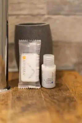 two bottles of medicine sitting on a wooden table at Luma Home in Rome