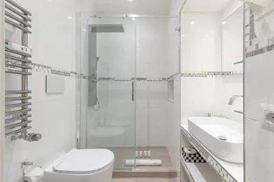 a white bathroom with a toilet and a sink at Dolce Vita New Studio in Rome