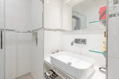 a white bathroom with a sink and a shower at Dolce Vita New Studio in Rome