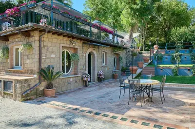a patio with a table and chairs in front of a house at Domus Luxury Gianicolo in Rome