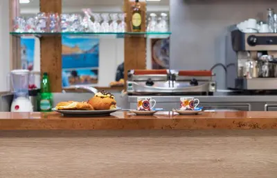 a counter with two cups of coffee and pastries at Hotel Balilla in Rome