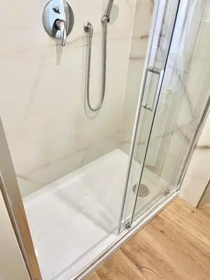 a shower stall with a glass shower door at Casa della Salita San Pietro in Rome