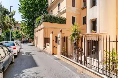 a street with cars parked next to a building at Casa della Salita San Pietro in Rome
