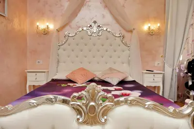 a bedroom with a large bed with a large headboard at Deluxe rooms and One Chilling jacuzzi Suite Guesthouse in Rome