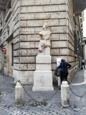 a woman standing next to a statue on the side of a building at Roma TouristHome via palestro 56 in Rome