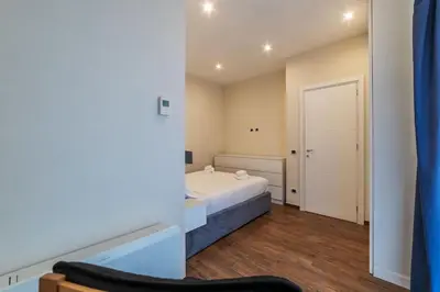 a bedroom with a white bed and a door at GuestHost - Sallustiano Apartments in Rome
