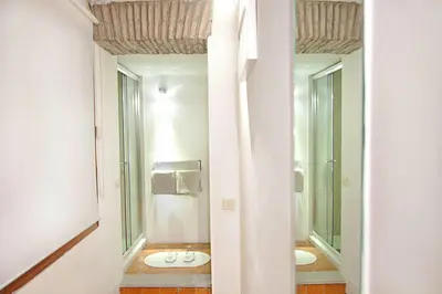 a bathroom with two sinks and a toilet at Arenula Luxury Apartment in Rome