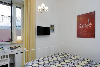 a bedroom with a bed and a tv on the wall at Domus Ponte Milvio in Rome