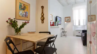 a dining room with a wooden table and chairs at Rental in Rome Beato Angelico in Rome