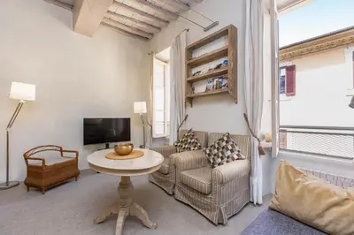 a living room with a couch and a table and a tv at Rental in Rome Leonardo da Vinci in Rome