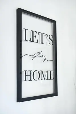 a picture frame with the words lets stay home at Cozy studio Campo de Fiori in Rome