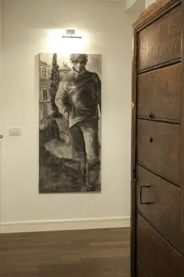 a painting of a man on a wall in a room at Relais Fori Imperiali in Rome