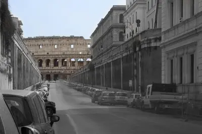 a black and white photo of a city street with cars at Relais Fori Imperiali in Rome