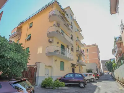 a yellow building with cars parked in front of it at Apartment Aurelia by Interhome in Rome
