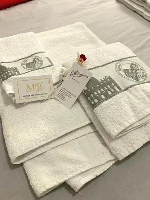 a pile of towels sitting on top of a bed at La Casa di Emanuela in Rome