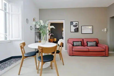a living room with a table and a red couch at YCH-Bright Penthouse near COLOSSEUM in Rome