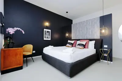 a bedroom with a large bed and a desk at YCH-Bright Penthouse near COLOSSEUM in Rome