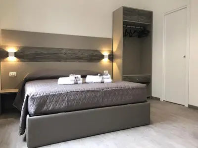 a bedroom with a bed with white pillows on it at BorgoNove in Rome