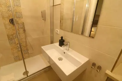 a bathroom with a white sink and a shower at BorgoNove in Rome