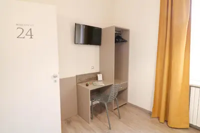 a room with a desk and a tv on a wall at BorgoNove in Rome