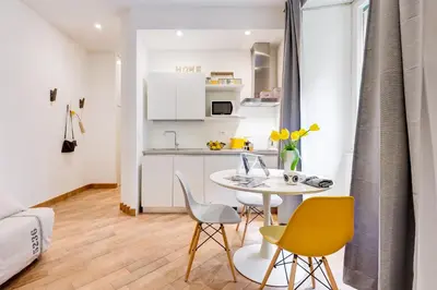 a small kitchen and dining room with a table and chairs at Vasari's Home in Rome