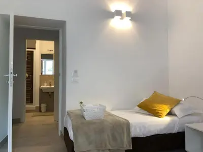 a bedroom with a bed and a light on the wall at Angolo sul Giardino in Rome