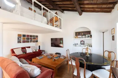 a living room with a table and a couch at Farnese Stunning Penthouse | Romeloft in Rome