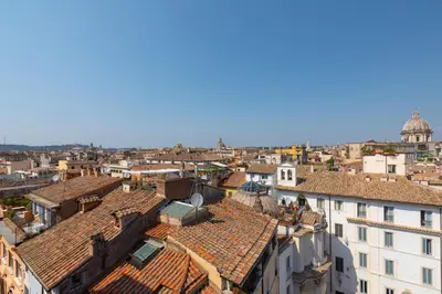 an aerial view of a city with roofs at Farnese Stunning Penthouse | Romeloft in Rome