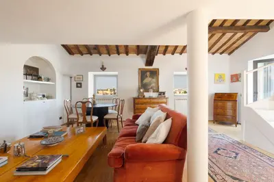 a living room with a couch and a table at Farnese Stunning Penthouse | Romeloft in Rome