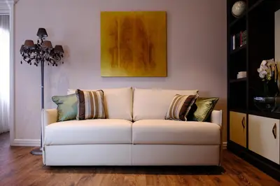 a white couch with pillows on it in a living room at San Pietro Rhome in Rome