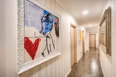 a hallway with a large painting on the wall at Boutique Rome Inn in Rome