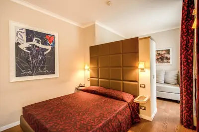 a hotel room with a bed and a couch at Boutique Rome Inn in Rome