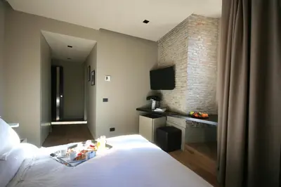 a hotel room with a bed and a television at Campo Marzio Luxury Suites in Rome