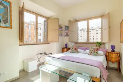 a bedroom with a large bed and two windows at Temple View FCollection Superior Relais in Rome