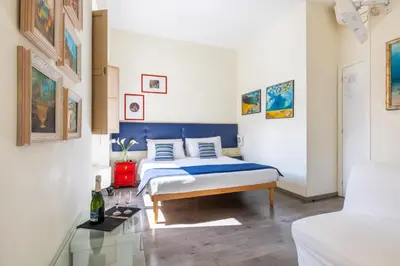 a bedroom with a bed with a blue headboard at Temple View FCollection Superior Relais in Rome