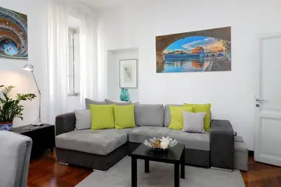 a living room with a couch and a table at LUXURY APARTMENT VATICANO-S'PETER BASILICA - NETFLIX Wifi - AirCond in Rome