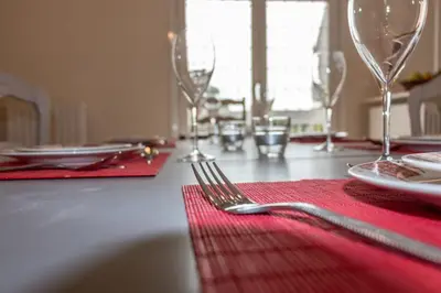 a fork sitting on a table with a red napkin at La camelia bianca in Rome