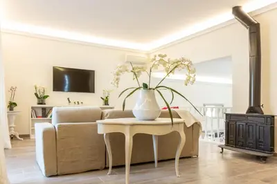 a living room with a couch and a table with a vase on it at La camelia bianca in Rome