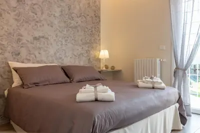 two towels on a bed in a bedroom at La camelia bianca in Rome