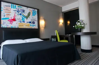 a hotel room with a bed and a table and a painting at Twentyone Hotel in Rome