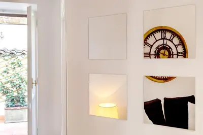 a room with a window and a clock on the wall at Domus Maya Colosseum in Rome