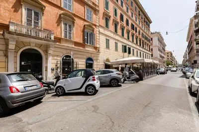 a group of cars parked on the side of a street at BMGA l Central Holiday House 2Bdr near Vatican in Rome