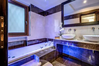 a bathroom with two sinks and a tub at Boutique Relais Barozzi & SPA in Rome