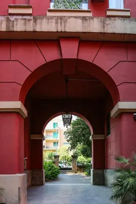 an entrance to a red building with an archway at Pamphili Park Romantic Retreat in Rome