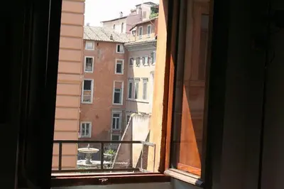 an open window with a view of a building at Portico d'Ottavia, the ancient Rome in Rome